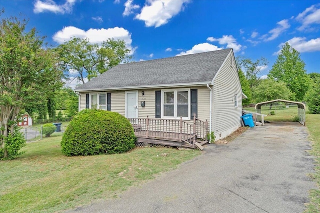 view of front of home with a front lawn, driveway, crawl space, a detached carport, and a shingled roof