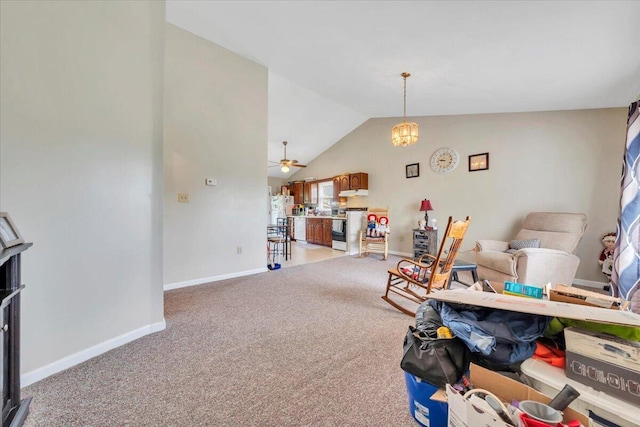 rec room featuring vaulted ceiling, light colored carpet, baseboards, and a ceiling fan