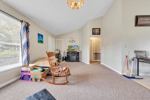 game room featuring healthy amount of natural light, baseboards, carpet, a chandelier, and high vaulted ceiling