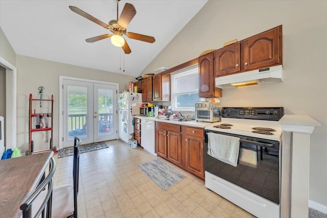 kitchen featuring white appliances, under cabinet range hood, french doors, vaulted ceiling, and a sink