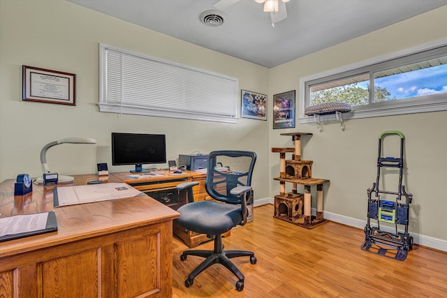 office area featuring light wood-style floors, ceiling fan, and baseboards