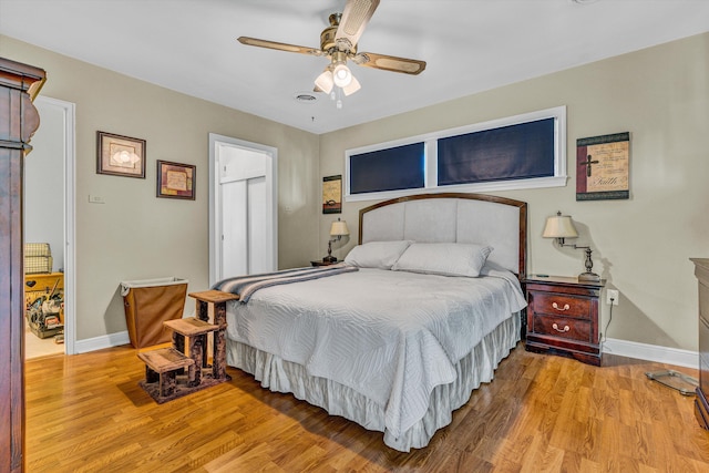 bedroom with baseboards, wood finished floors, and a ceiling fan