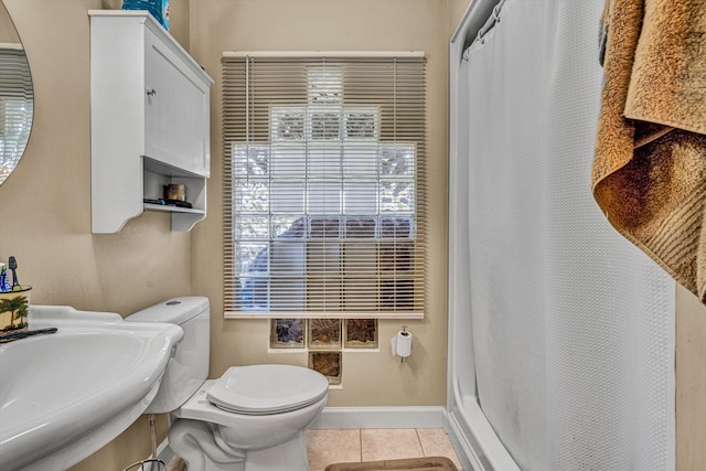 bathroom with a sink, tile patterned flooring, toilet, a shower with shower curtain, and baseboards