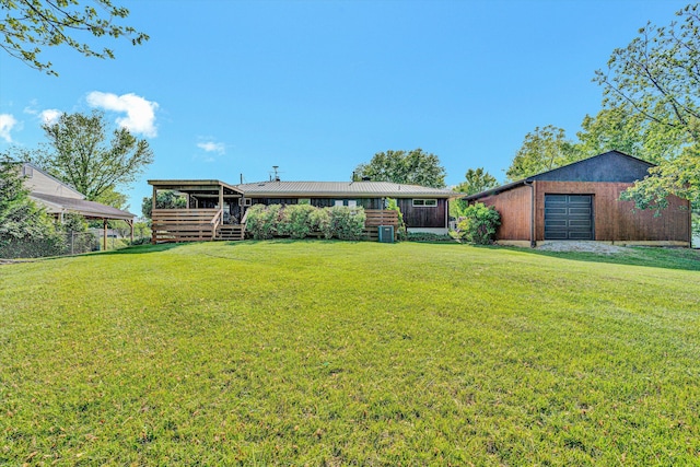 ranch-style house featuring a front lawn, an outbuilding, and metal roof