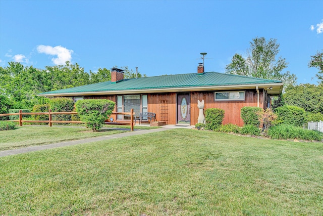 single story home featuring a chimney and metal roof