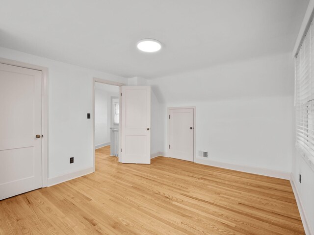 bonus room with light wood-style flooring and baseboards
