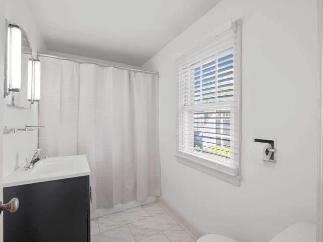 full bathroom with marble look tile flooring, toilet, vanity, and a shower with shower curtain