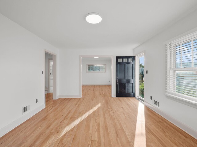 foyer with light wood-type flooring and baseboards