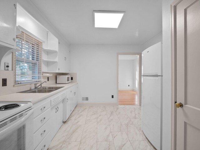 kitchen featuring white appliances, light marble finish floors, white cabinets, light countertops, and open shelves