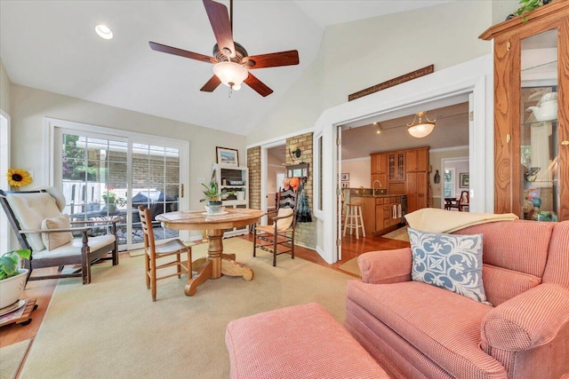 living room with a ceiling fan, high vaulted ceiling, and recessed lighting