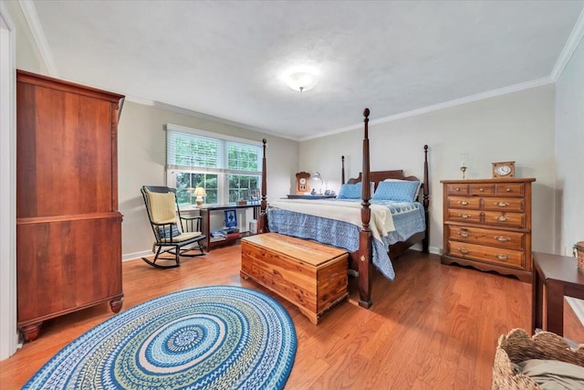 bedroom featuring light wood-style flooring, ornamental molding, and baseboards