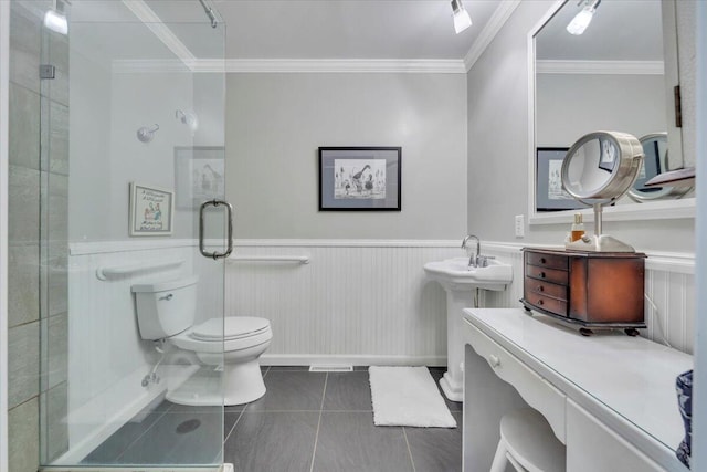 full bathroom with a shower stall, toilet, crown molding, tile patterned flooring, and wainscoting