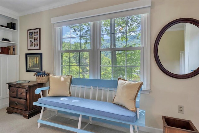 living area with ornamental molding, plenty of natural light, and carpet flooring