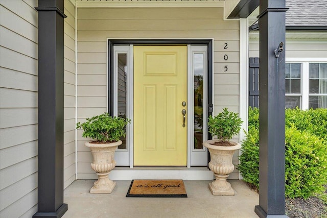 entrance to property with roof with shingles