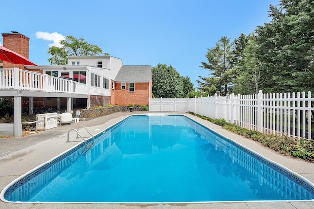 view of pool with a fenced backyard, a patio, and a deck