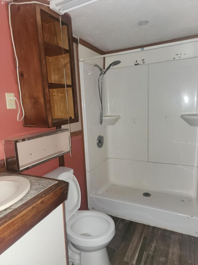 1742 Fruitridge Dr, Penhook, VA 24137 - bathroom with a stall shower, vanity, wood finished floors, and toilet