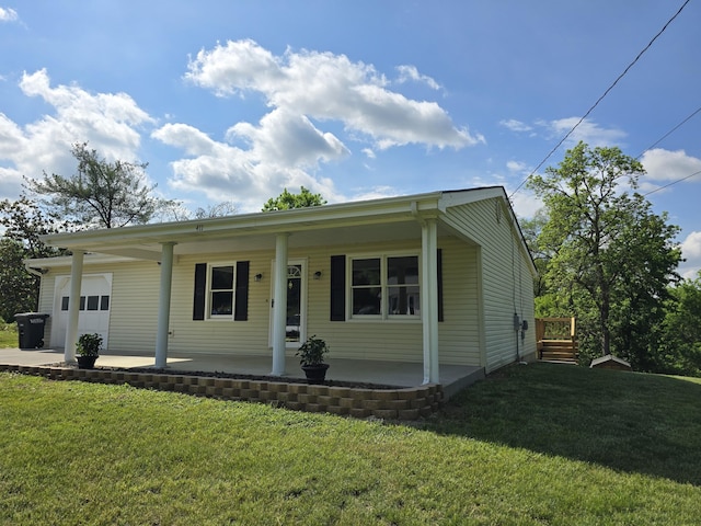 411 Raleigh Ave, Vinton, VA 24179 - ranch-style house with covered porch, an attached garage, and a front lawn