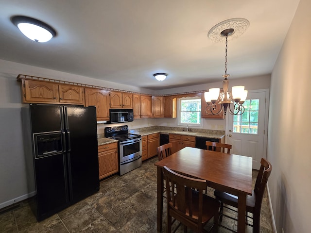 411 Raleigh Ave, Vinton, VA 24179 - kitchen featuring black appliances, a chandelier, brown cabinets, a sink, and hanging light fixtures