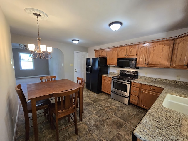 411 Raleigh Ave, Vinton, VA 24179 - kitchen featuring black appliances, a chandelier, and brown cabinets