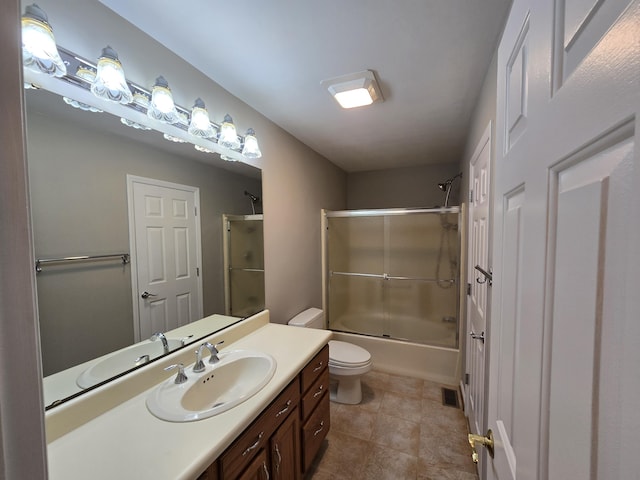 411 Raleigh Ave, Vinton, VA 24179 - full bathroom with vanity, toilet, combined bath / shower with glass door, and tile patterned floors