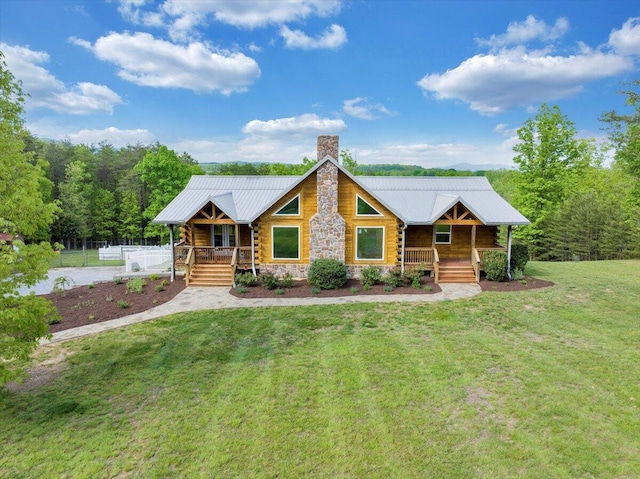 log cabin with a porch, a chimney, metal roof, and stone siding
