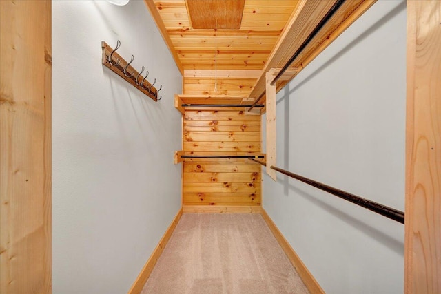 walk in closet featuring light colored carpet