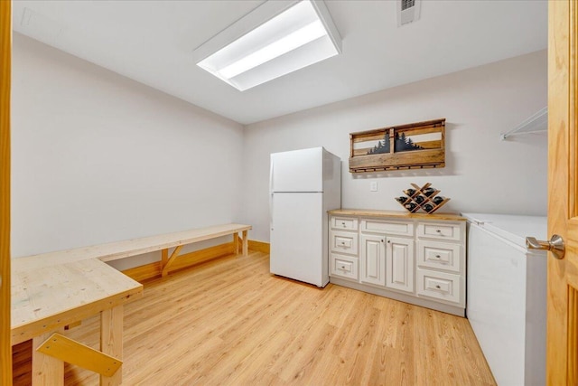 laundry area with light wood-style floors