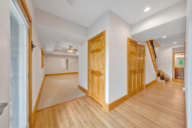 corridor with wood finished floors, baseboards, stairway, and recessed lighting