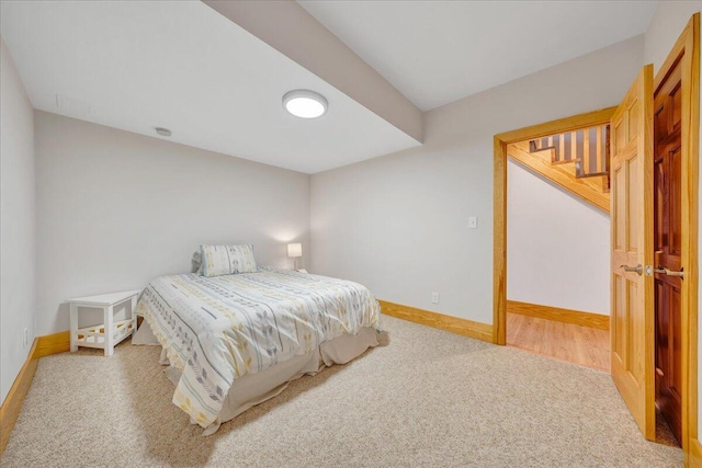 bedroom featuring carpet and baseboards