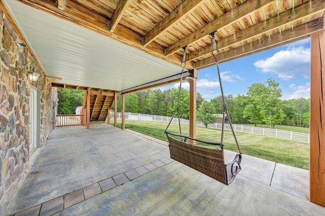view of patio / terrace with stairs and view of wooded area