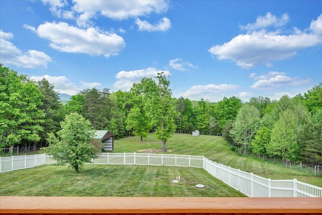 view of community with a forest view and an outbuilding
