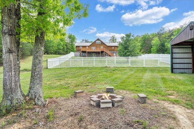 view of yard featuring a fire pit, a wooden deck, stairs, and an outbuilding