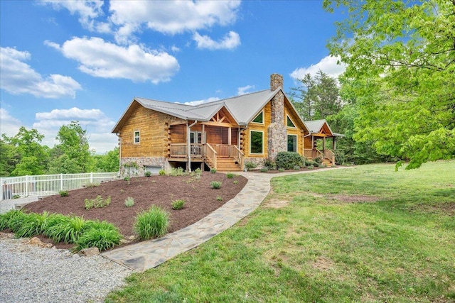 log-style house with a chimney, log exterior, and metal roof