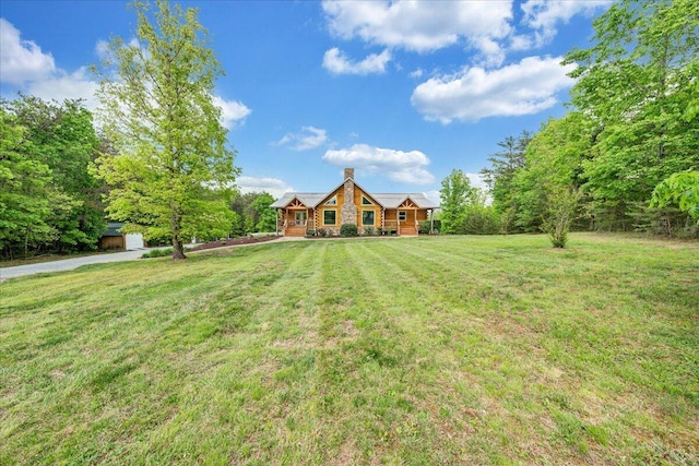 view of front of property featuring a front lawn and a chimney