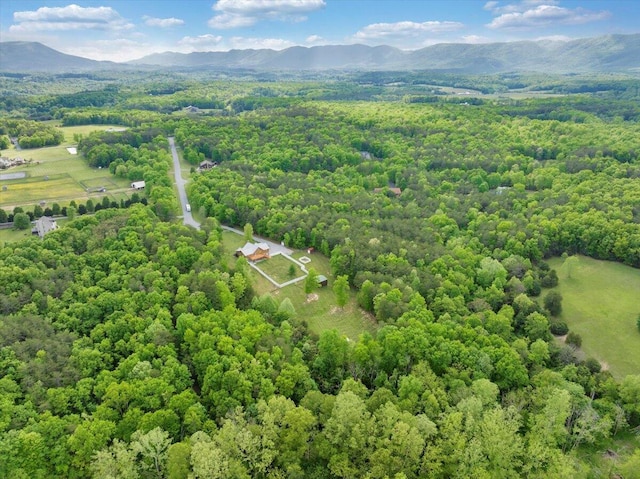 aerial view of a heavily wooded area and mountains