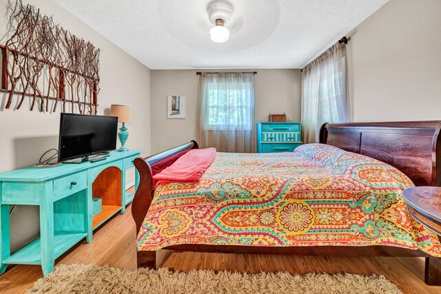bedroom featuring wood finished floors and ceiling fan