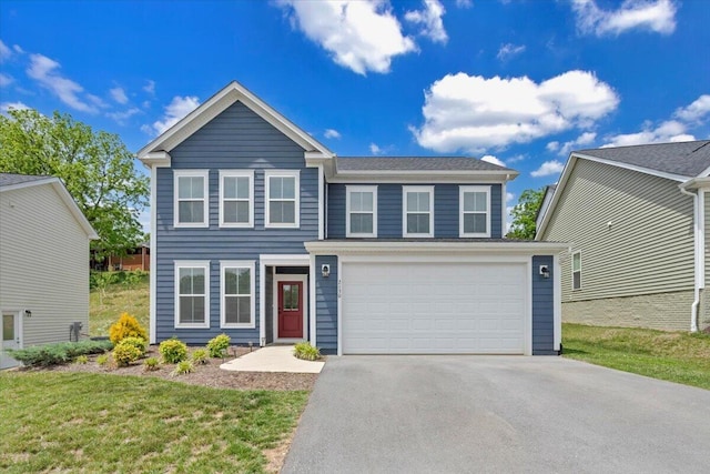 traditional-style house with asphalt driveway, an attached garage, and a front yard
