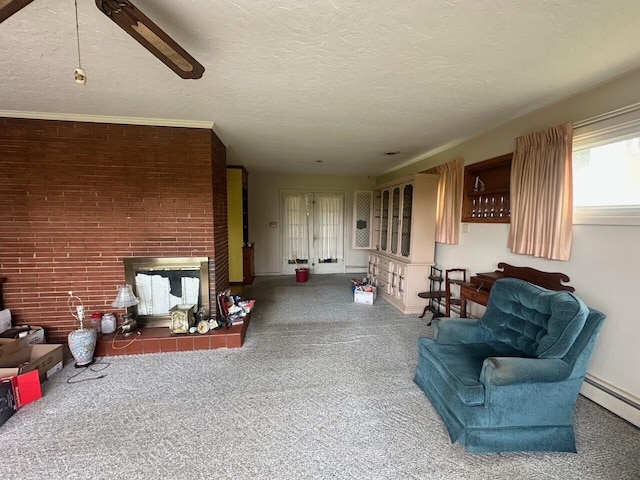 carpeted living area with baseboard heating, a fireplace, and baseboards