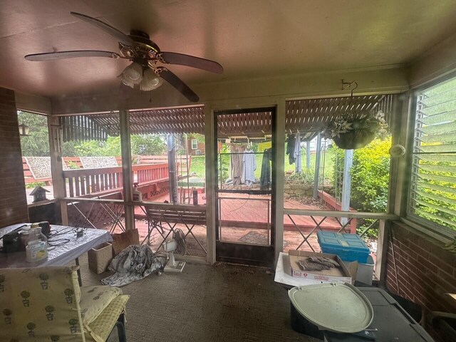 sunroom featuring a ceiling fan