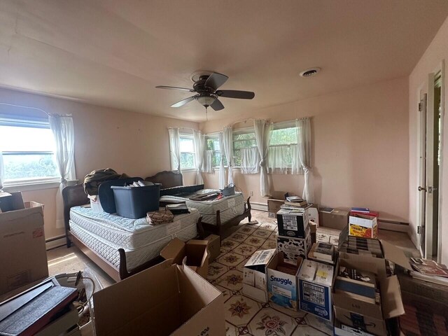 misc room featuring a ceiling fan and baseboard heating
