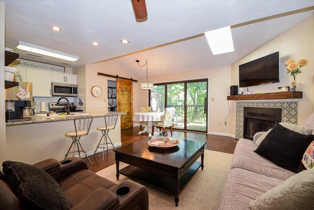 3279 Forest Ridge Rd, Roanoke, VA 24018 - living room featuring a barn door, lofted ceiling, recessed lighting, dark wood-style flooring, and baseboards