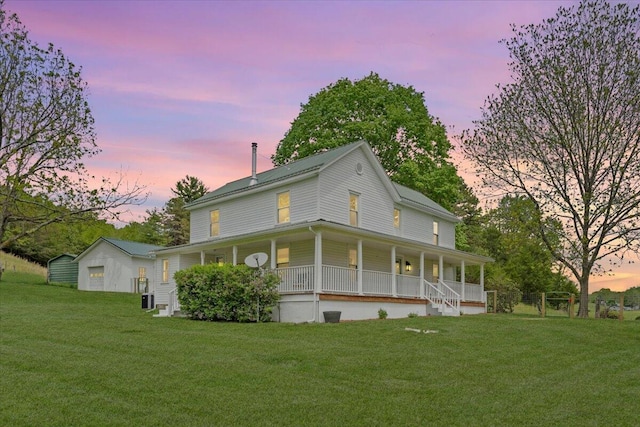 rear view of property featuring a porch, a lawn, and cooling unit
