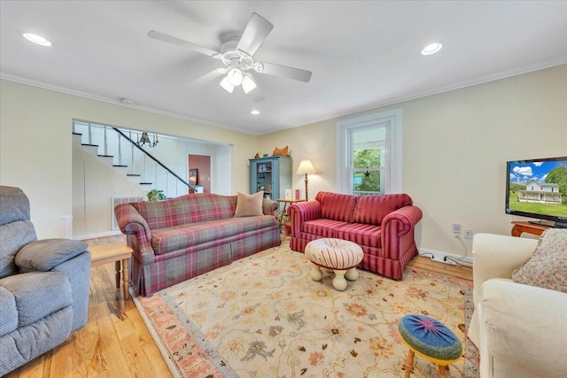 living area featuring wood finished floors, stairway, ornamental molding, ceiling fan, and recessed lighting