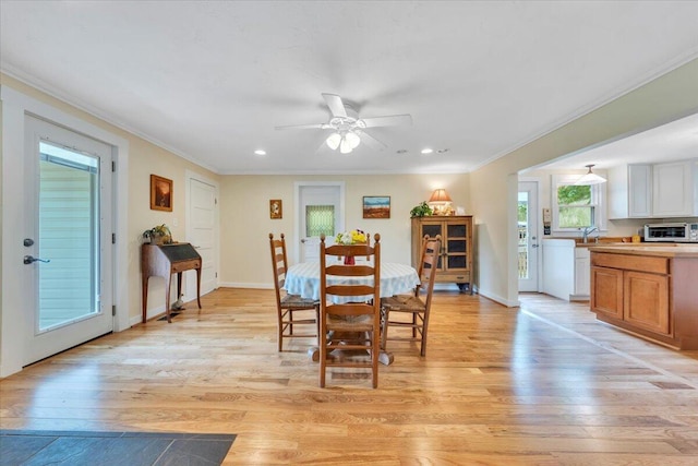 dining area with light wood-style floors, crown molding, ceiling fan, recessed lighting, and baseboards