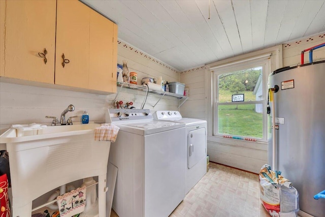 laundry room featuring cabinet space, independent washer and dryer, water heater, wood ceiling, and brick patterned floors