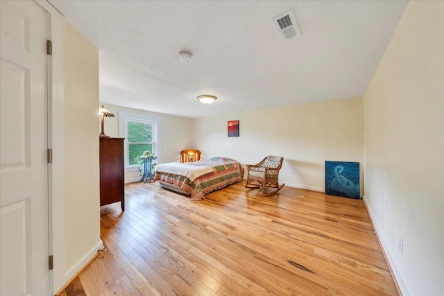 bedroom featuring light wood-style floors and baseboards