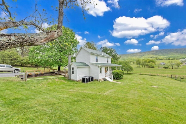 view of side of property with central AC and a view of rural / pastoral area