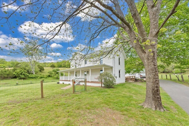 view of green lawn with a porch