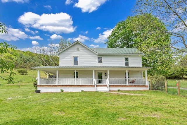 farmhouse with a porch and metal roof