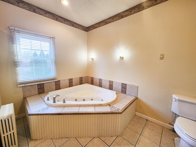 bathroom featuring radiator heating unit, toilet, a jetted tub, baseboards, and tile patterned flooring